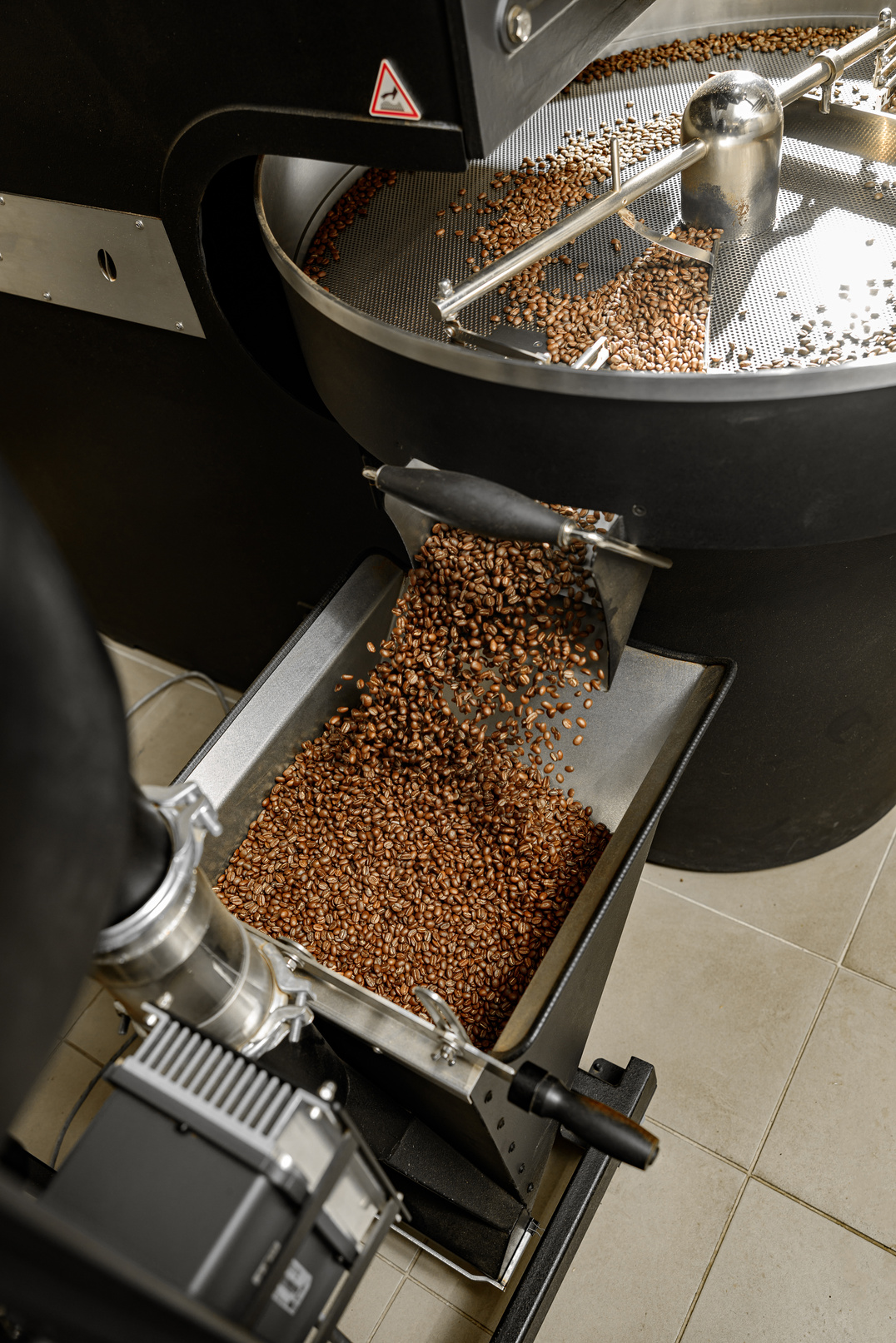 Coffee Processing. Roastery, Roasting Machine and Fresh Beans